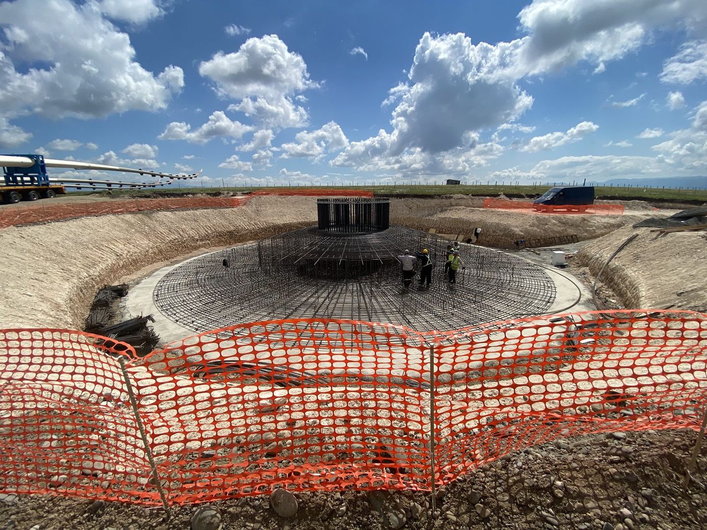 Wind turbine foundation excavation with blade transport truck